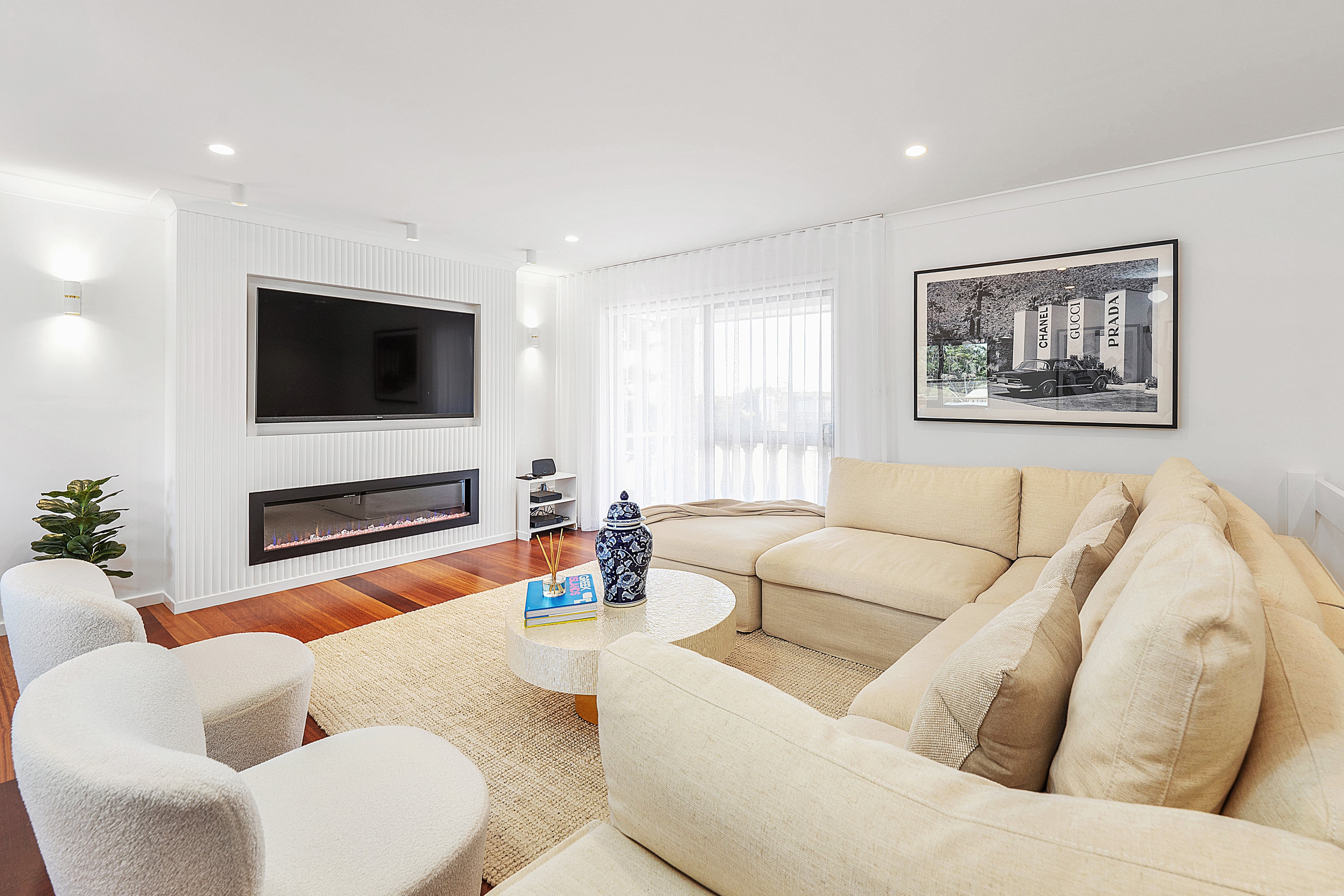 The Villa Southern Belle living room with electric fireplace and cream sectional